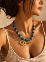 Collier "Regard Solaire" – Perles Bleues & Amulettes